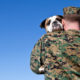 guy-in-military-uniform-holding-a-dog